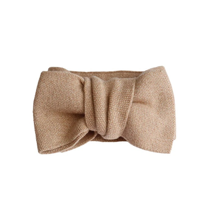 Beige headband with a large bow on a white background