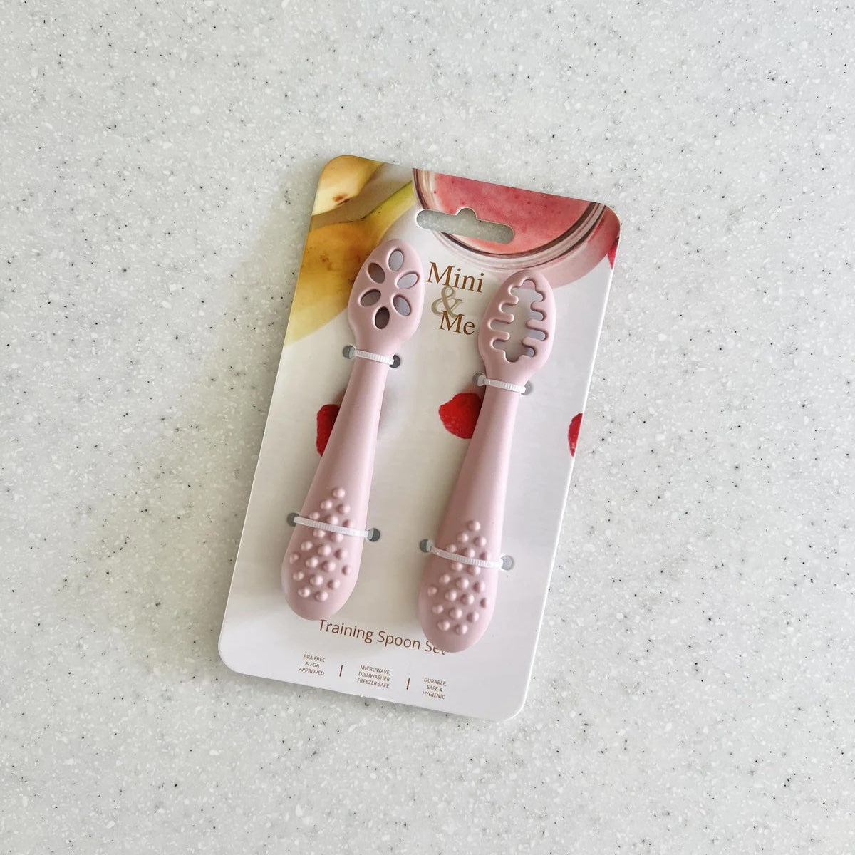 Pink training spoon set on a white background