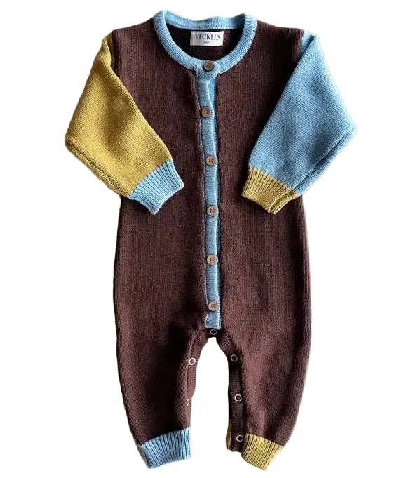 Children's brown knitted romper with colorful sleeves on a light gray background