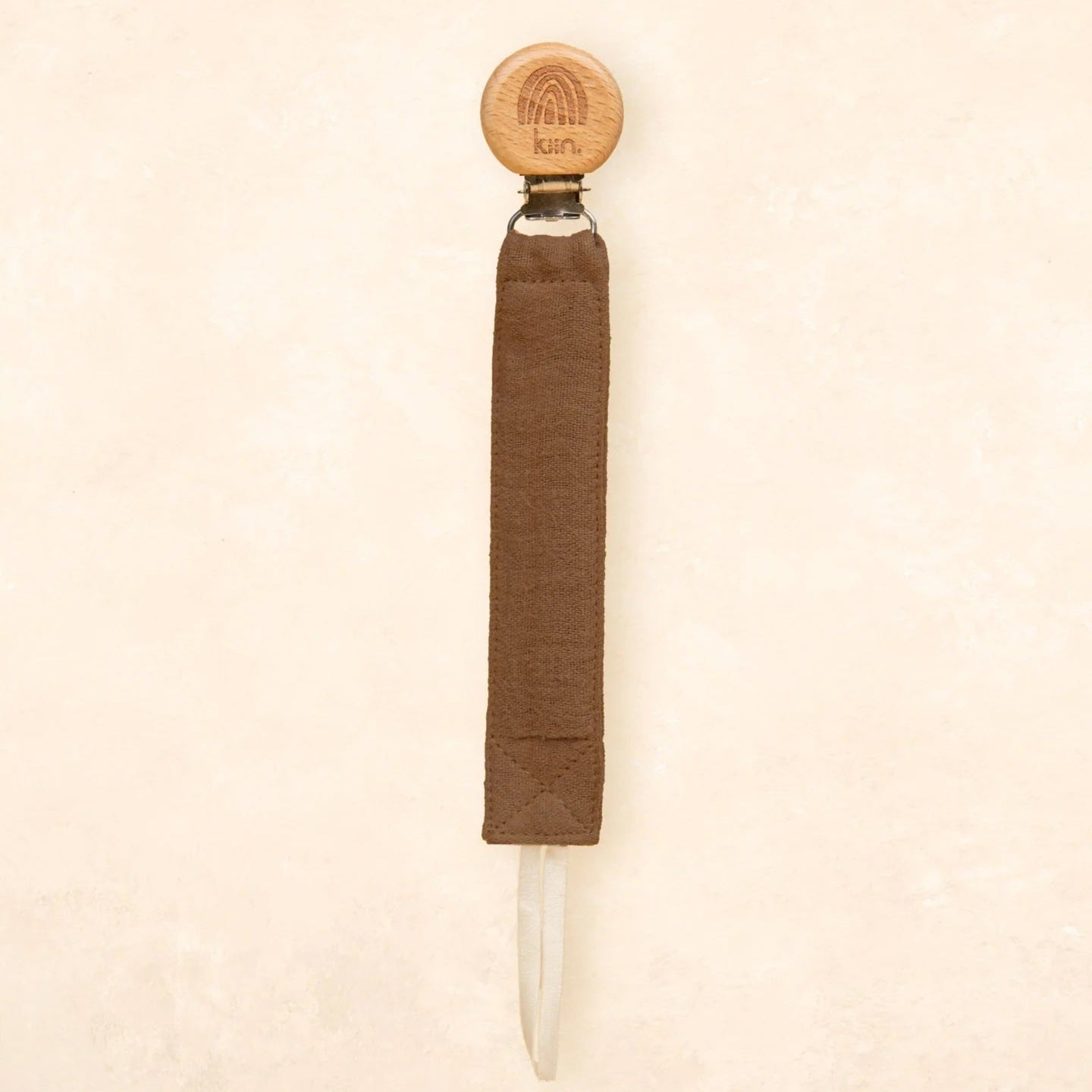 Knife with a wooden handle and sheath on a beige background