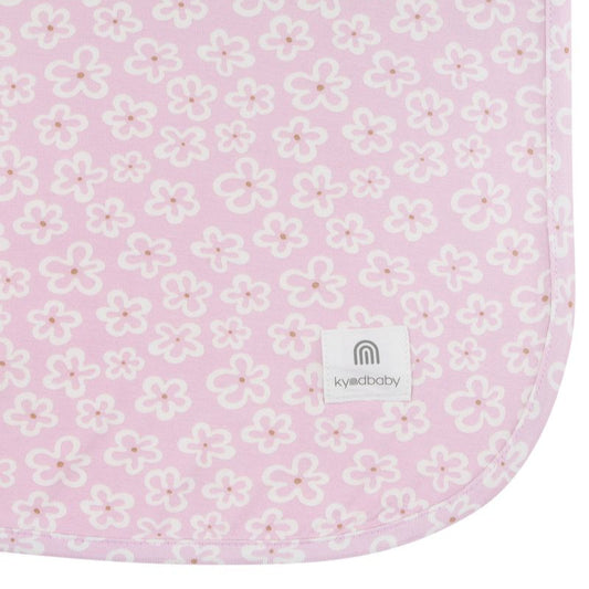 Floral patterned fabric with a visible brand logo on a pink background
