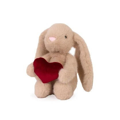 Plush bunny toy holding a red heart on a white background