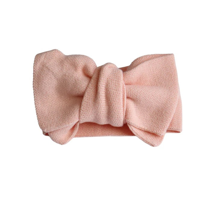 Pink headband with a bow on a white background
