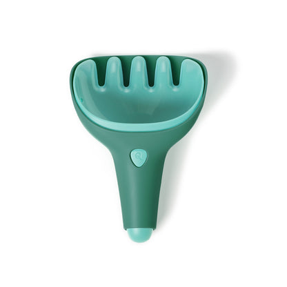 Green pet grooming tool on a white background