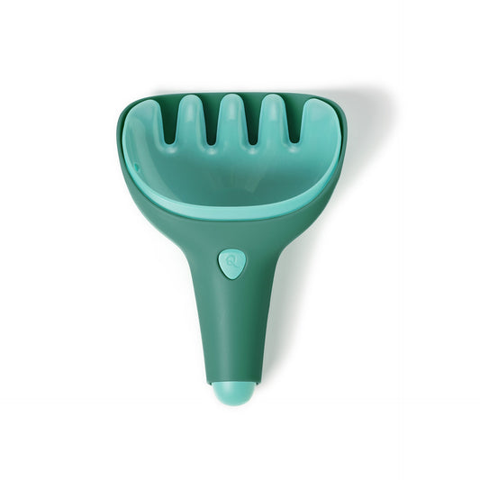 Green pet grooming tool on a white background