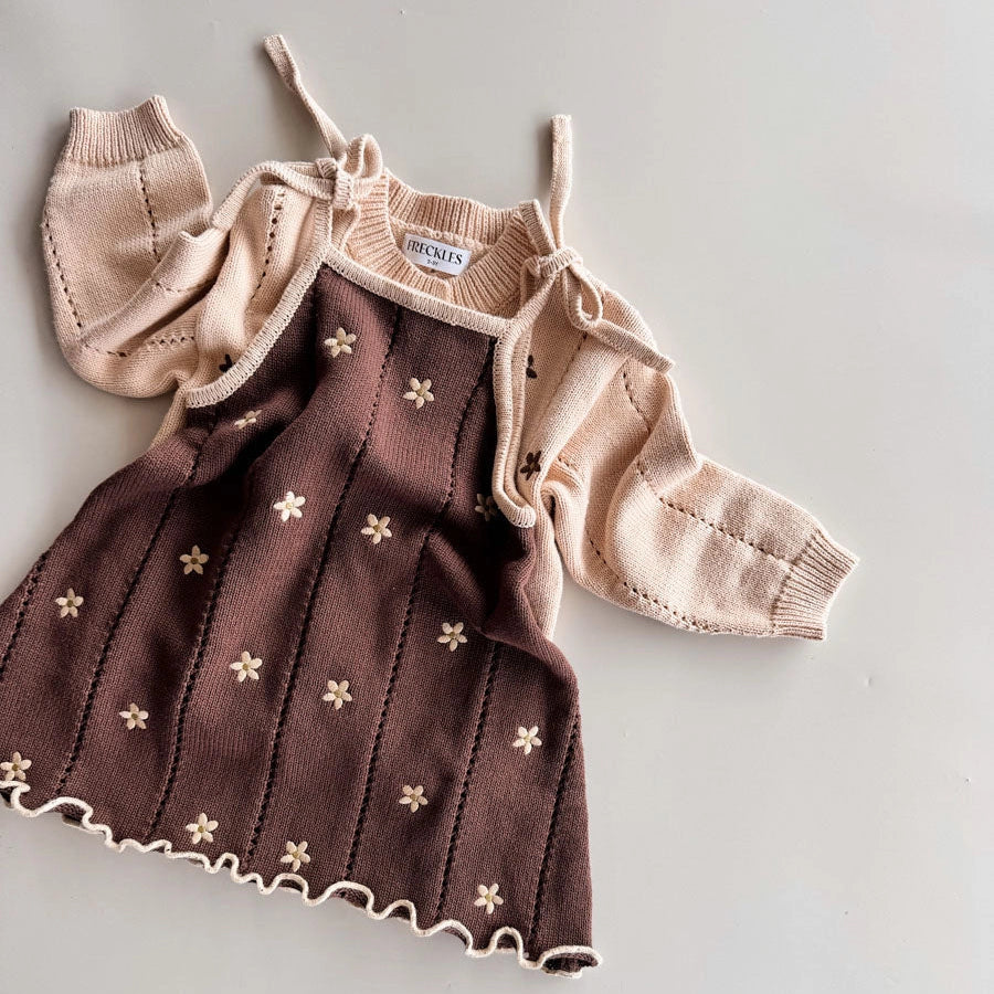 Children's brown dress with floral patterns and matching cardigan on a light gray background