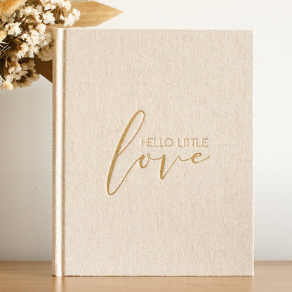 Beige book with 'Hello Little Love' text on a light background