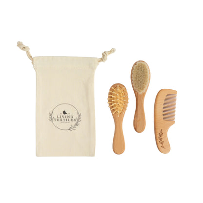 Set of wooden hairbrushes and comb with a branded pouch on a white background