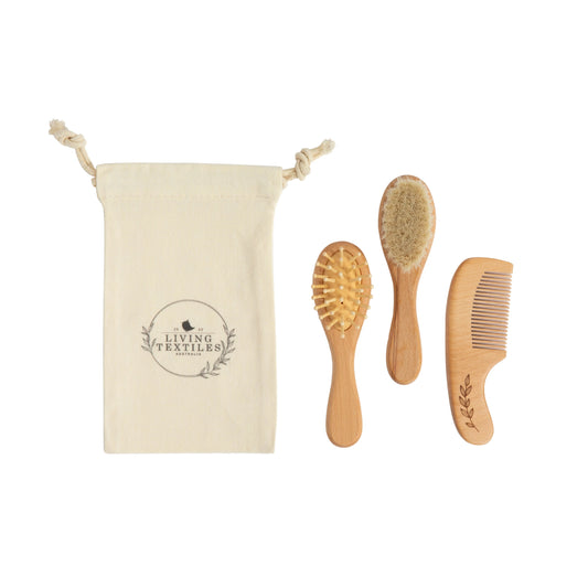 Set of wooden hairbrushes and comb with a branded pouch on a white background