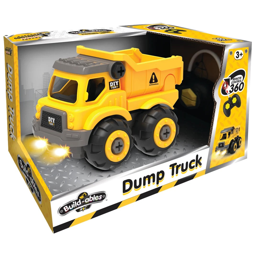 Buildables DIY remote control dump truck toy in its original retail packaging, featuring a yellow and gray truck with black wheels.