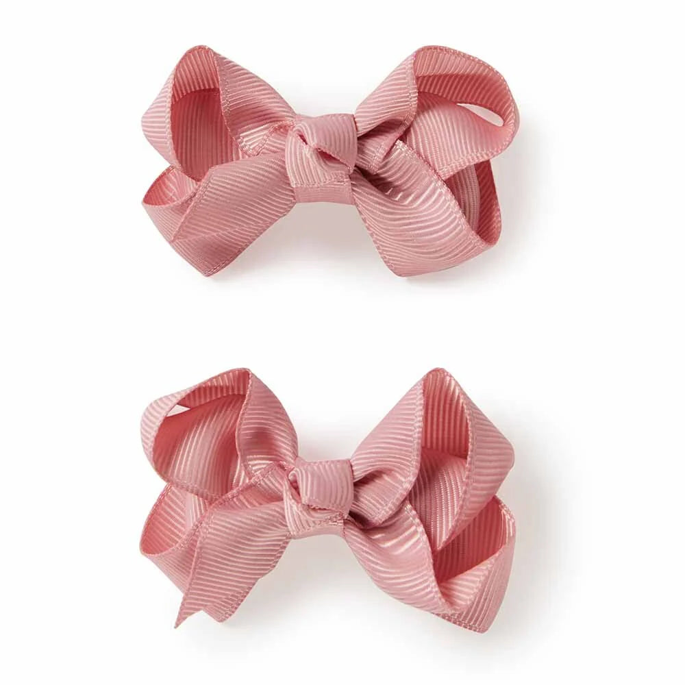 Two pink hair bows on a white background