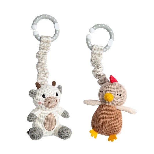 Two knitted animal toys with ribbons on a white background