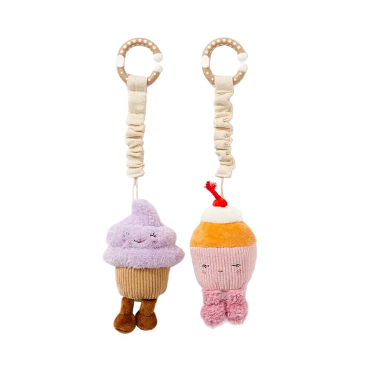Two plush ice cream cone toys with faces on a white background