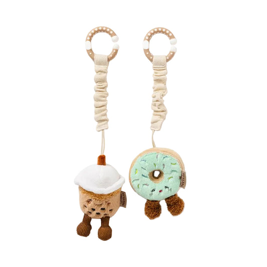 Two baby rattles shaped like a donut and a snowman on a white background