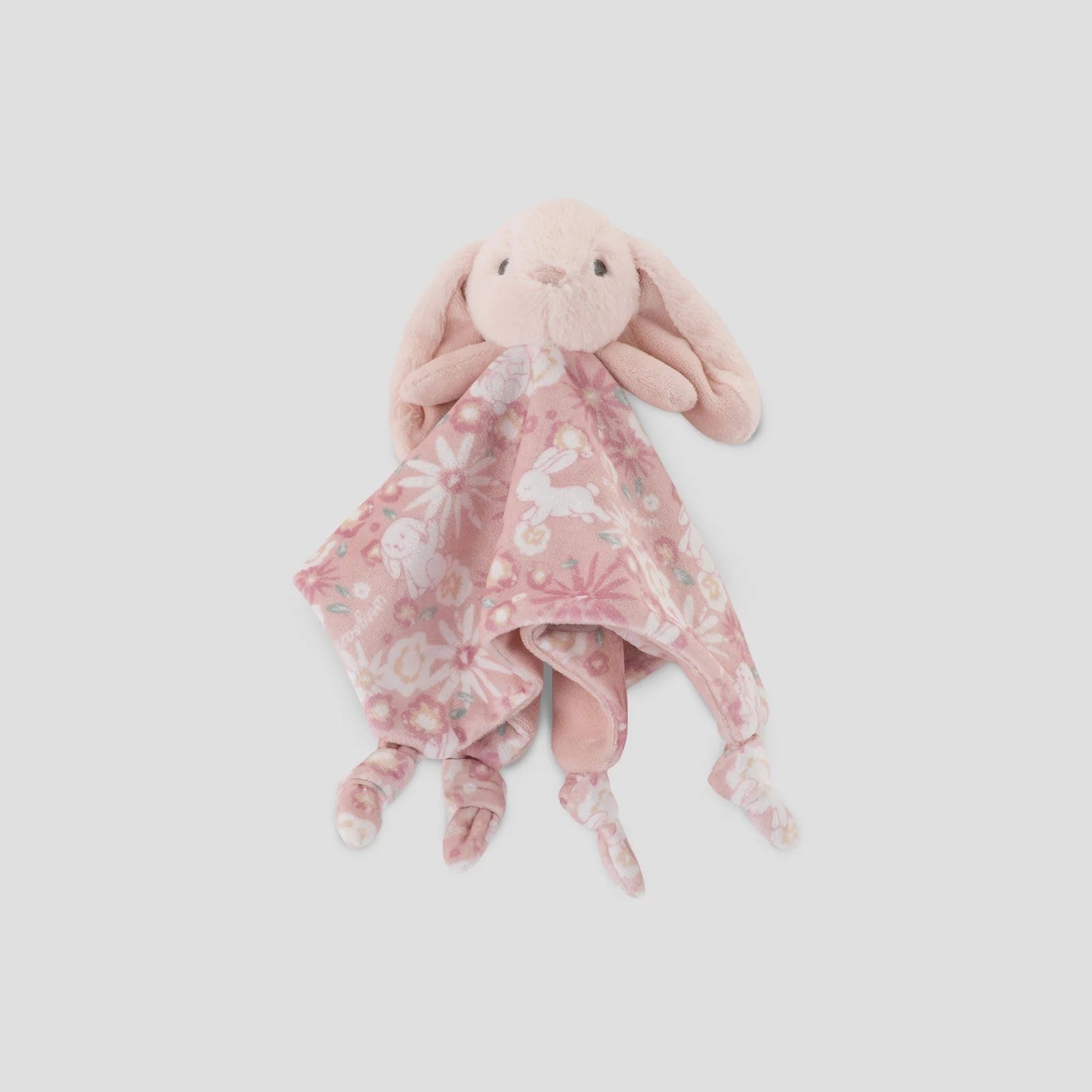 Pink plush bunny with a floral blanket on a light gray background