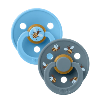 Two baby pacifiers with bee design on a white background
