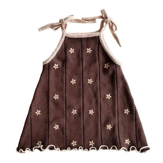 Brown dress with floral patterns on a light gray background
