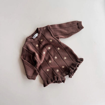 Brown baby outfit with star pattern on a light gray background