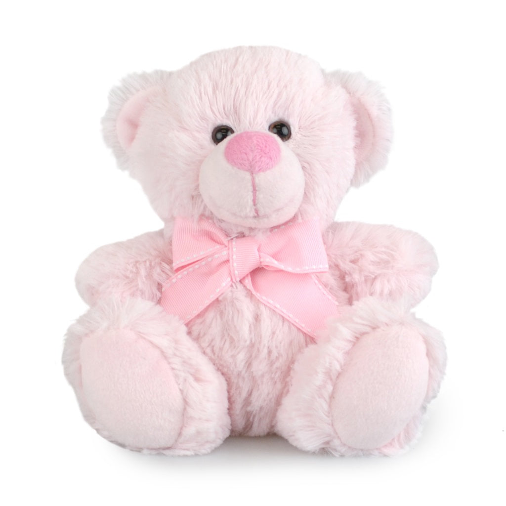 Pink teddy bear with a bow on a white background