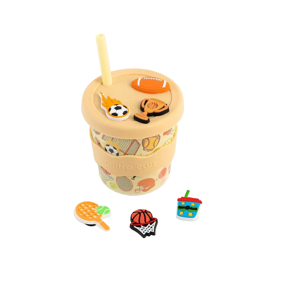 Colorful drink cup with various charms on a white background