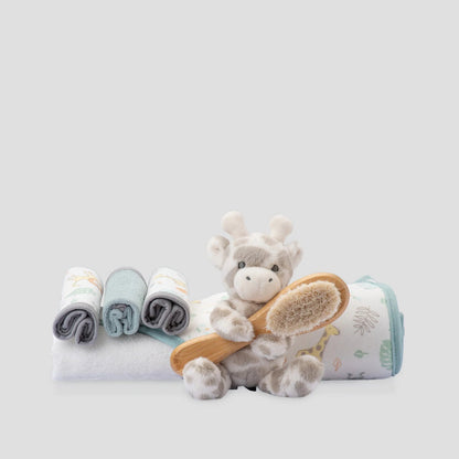 Baby care set with plush toy, washcloths, and brush on a light gray background
