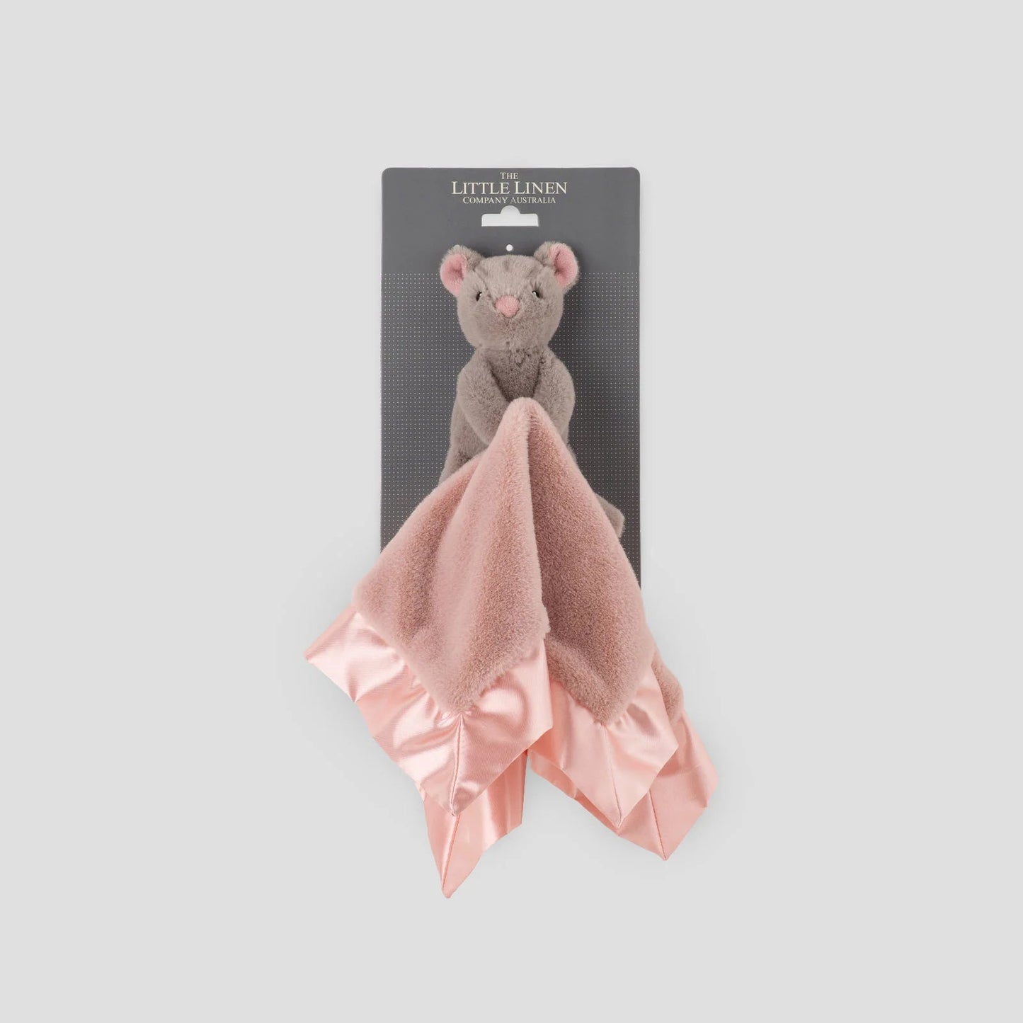 Pink ruffled towel with a gray mouse toy on a white background