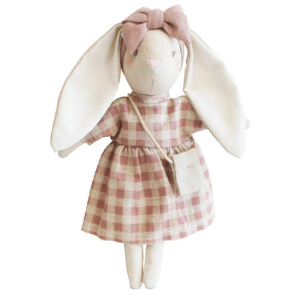 Stuffed bunny toy wearing a pink checkered dress on a white background