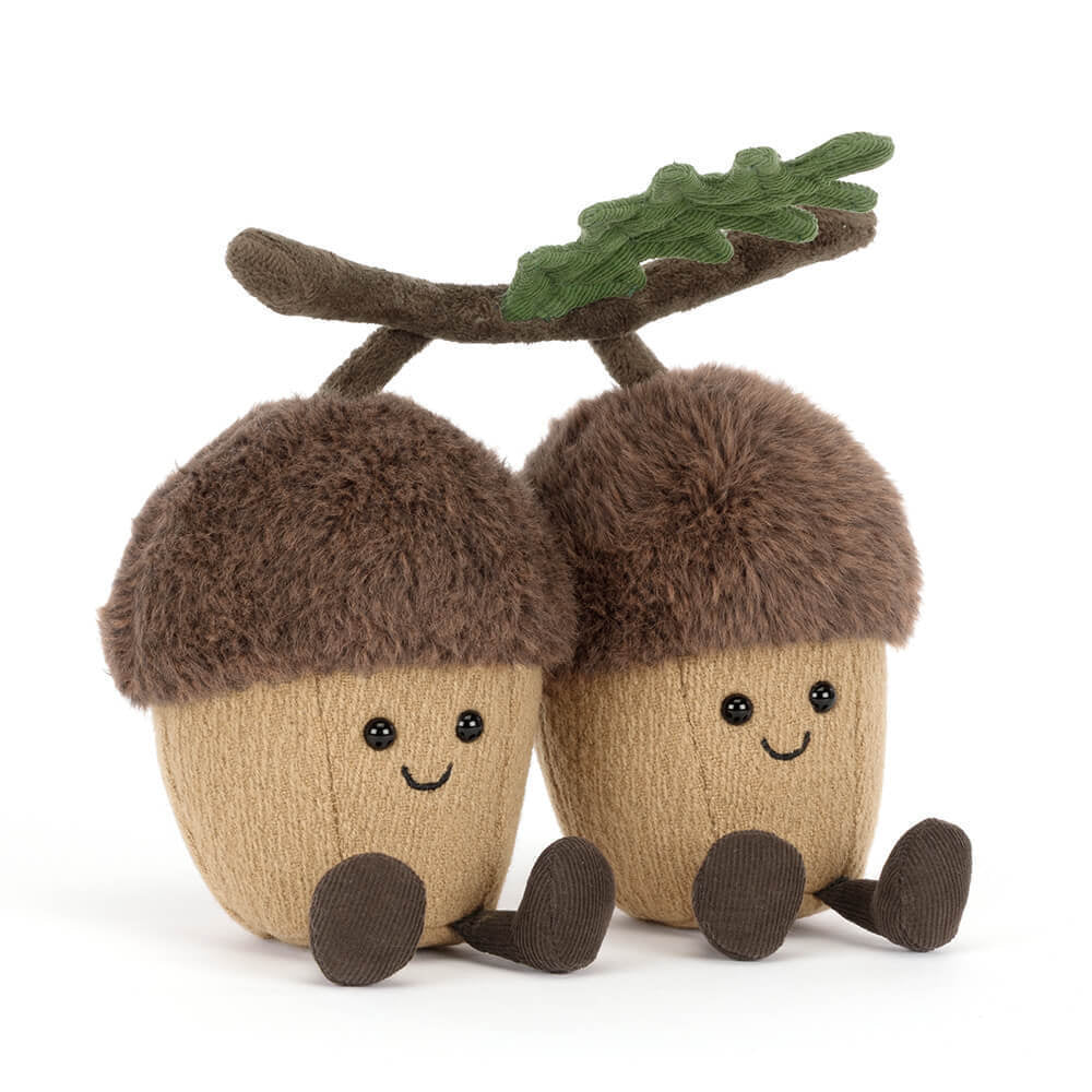 JELLYCAT Two plush acorns with faces and a branch on a white background