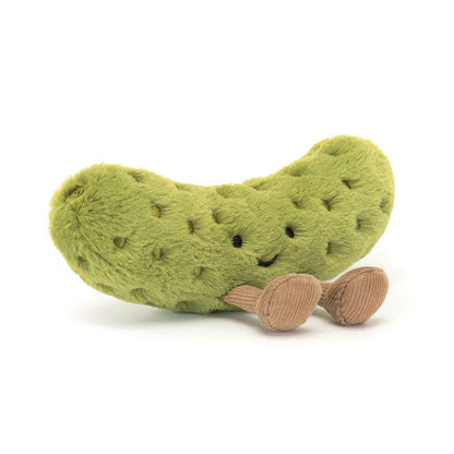 Plush pickle toy with a smiling face on a white background