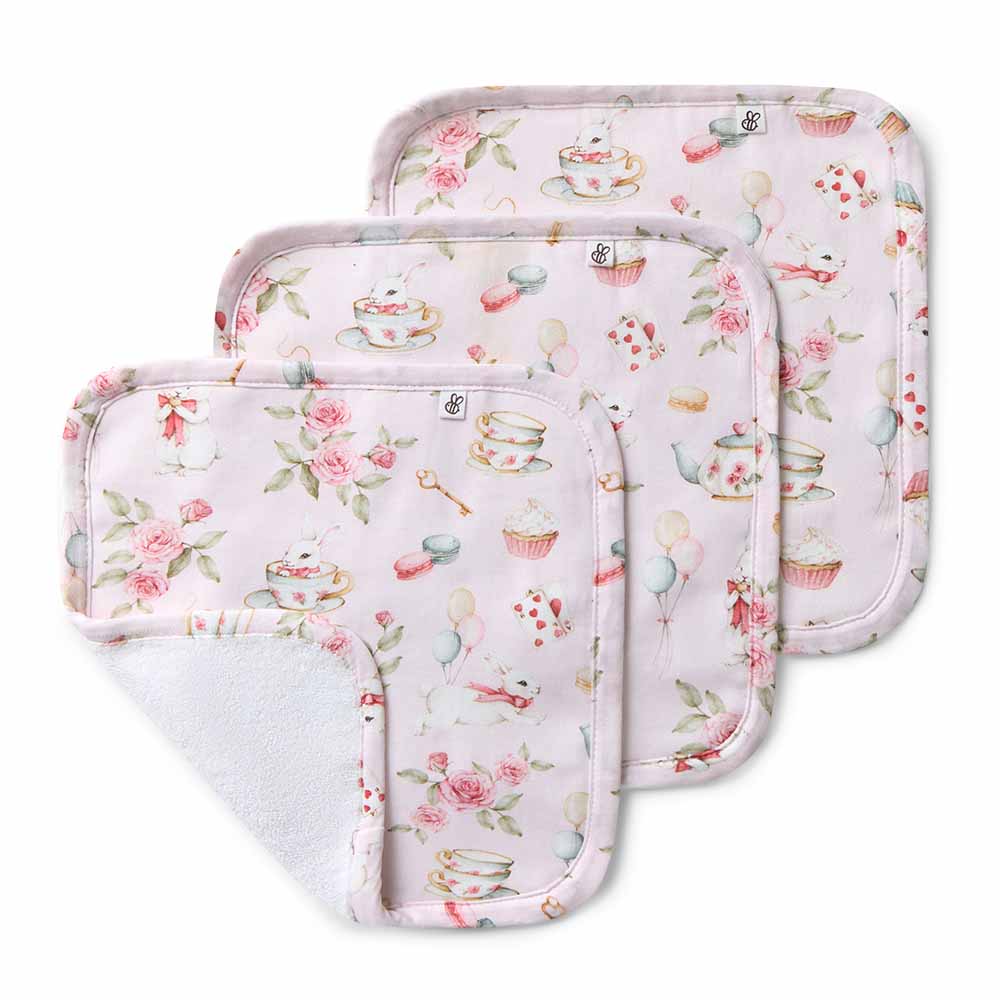 Three floral-patterned baby burp cloths on a white background