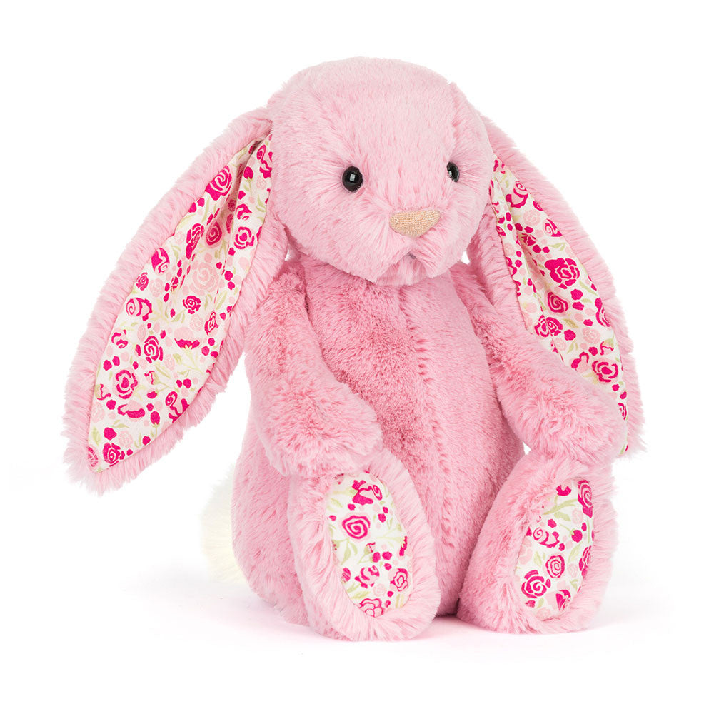 Pink plush bunny with floral patterns on a white background