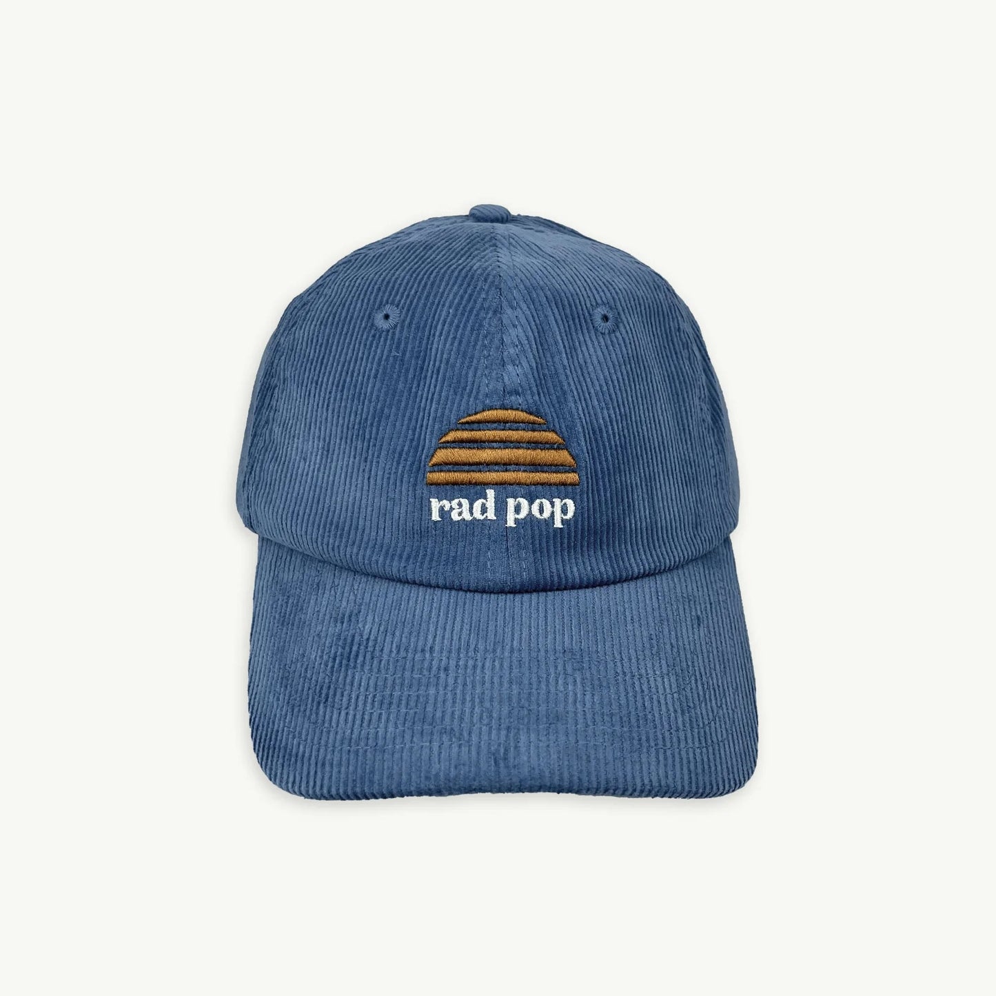 Blue corduroy cap with 'rad pop' text and logo on a white background
