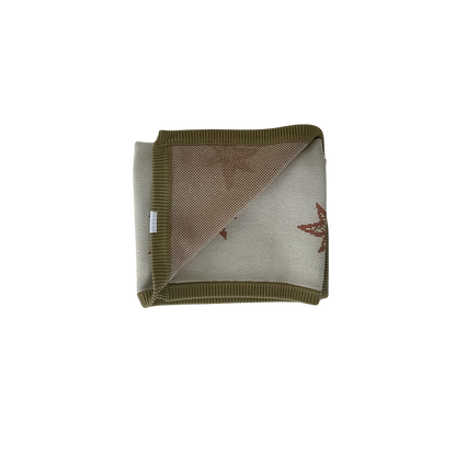 Folded fabric with a geometric pattern on a white background