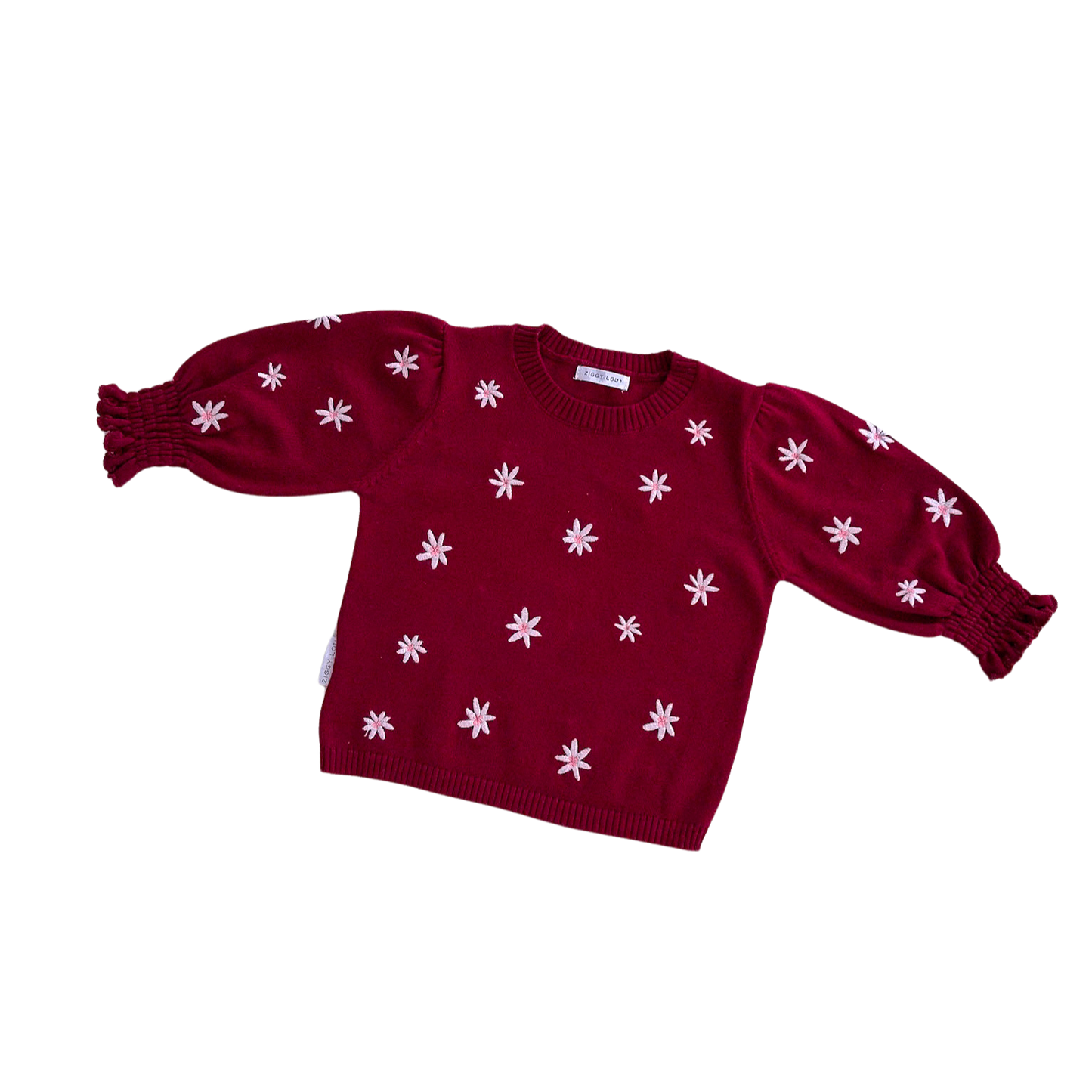 Red sweater with white floral patterns on a white background
