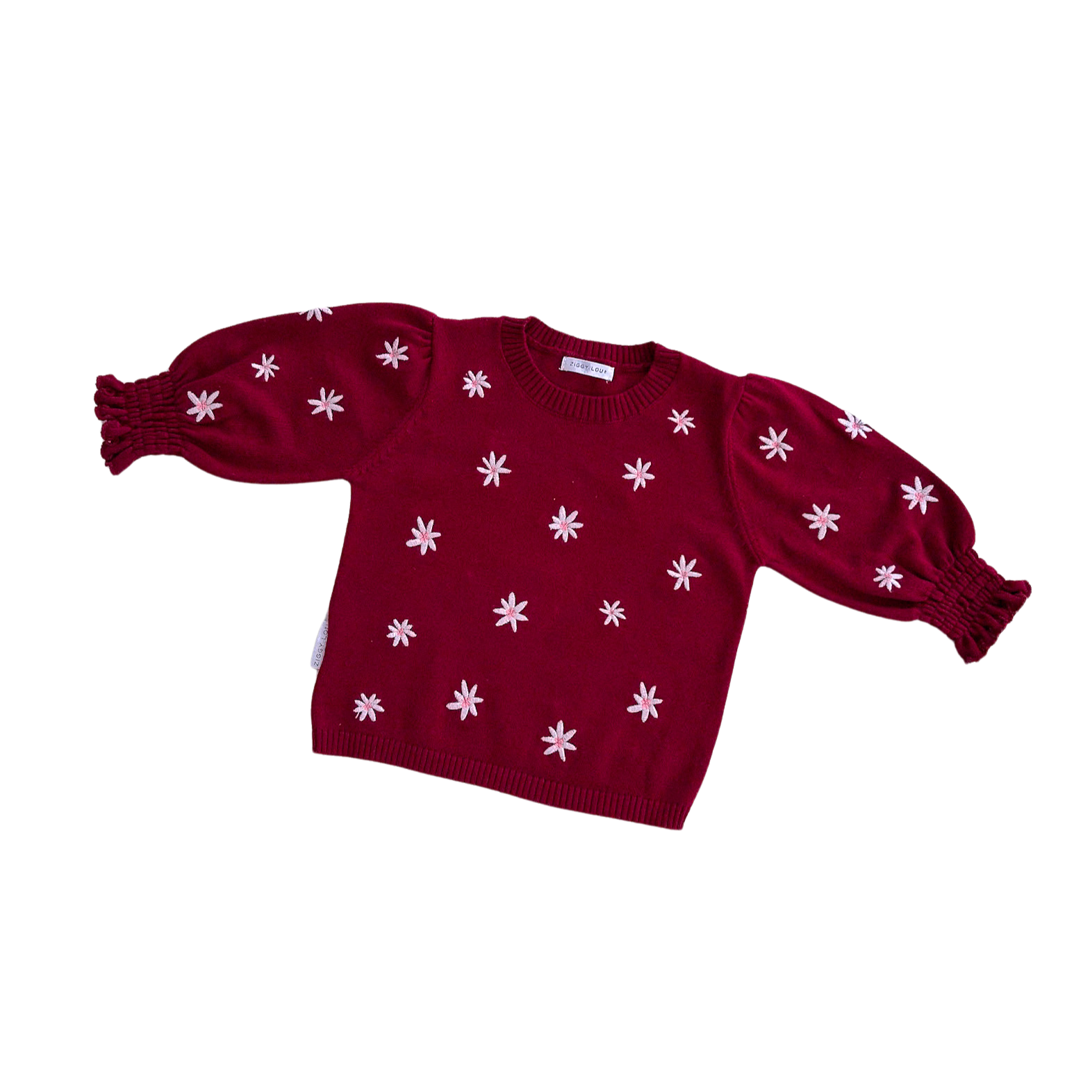 Red sweater with white floral patterns on a white background