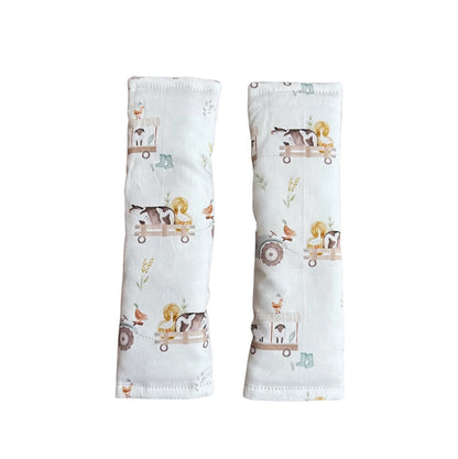 Two baby arm sleeves with animal prints on a white background