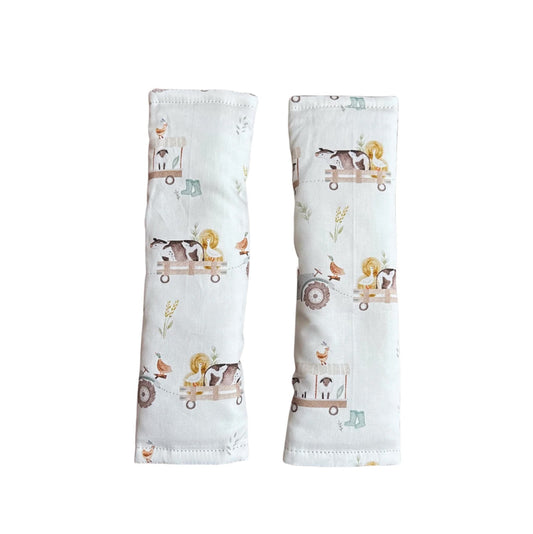 Two baby arm sleeves with animal prints on a white background