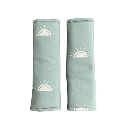 Two light blue fabric swaddles with white sun designs on a white background