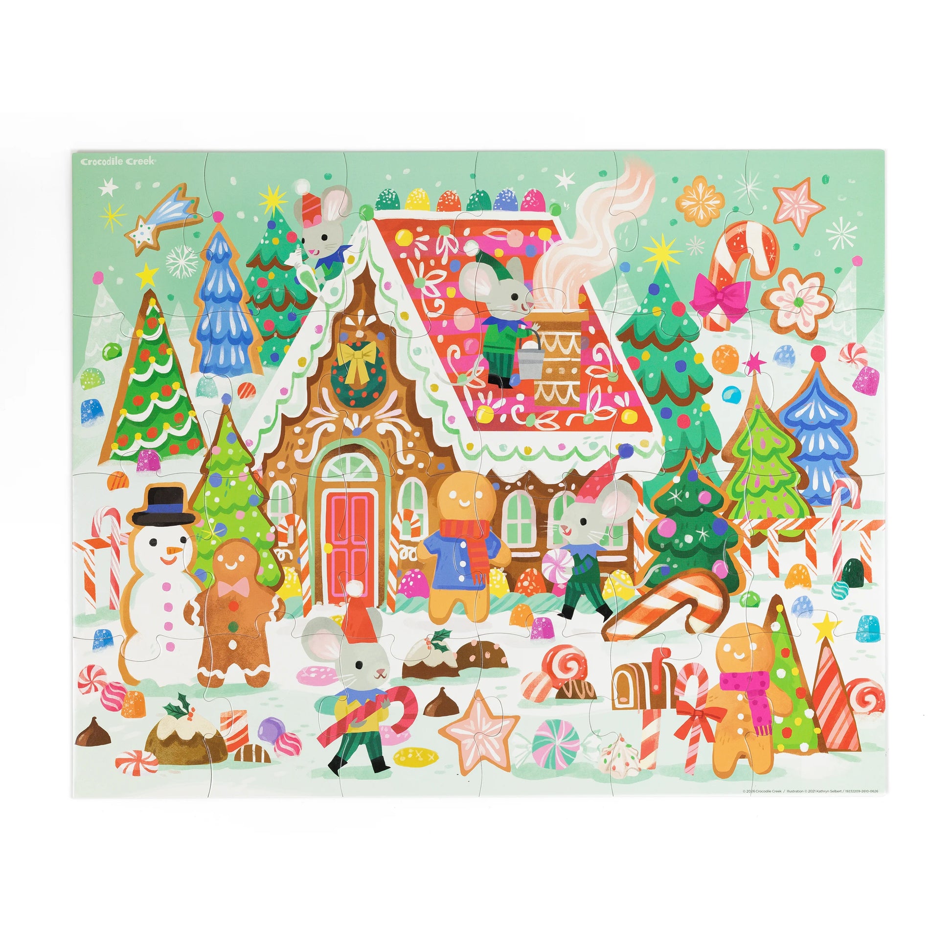 A colorful Christmas gingerbread-themed jigsaw puzzle featuring a decorated gingerbread house, candy canes, snowman, and playful animals on a mint green background.
