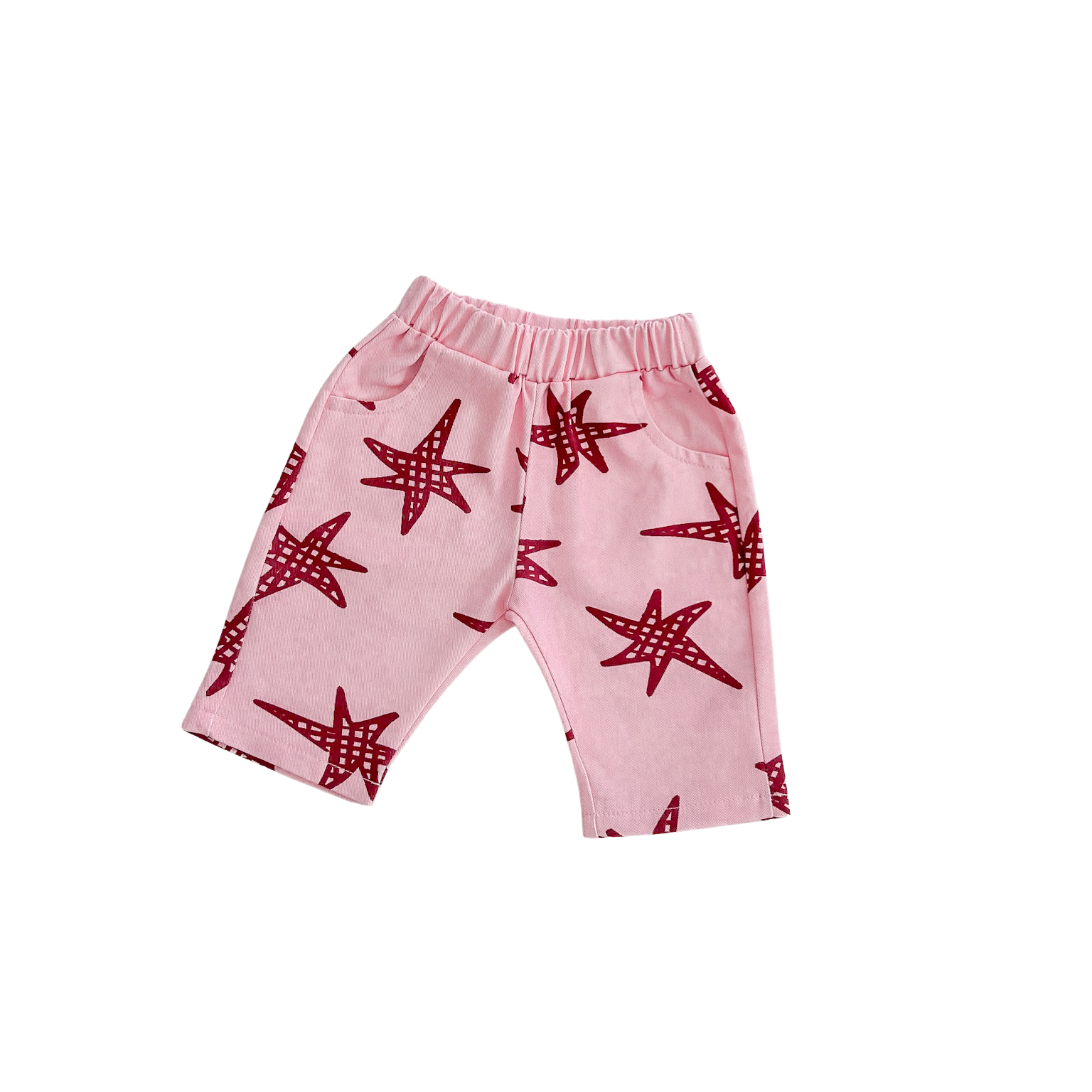 Pink pants with red starfish pattern on a white background