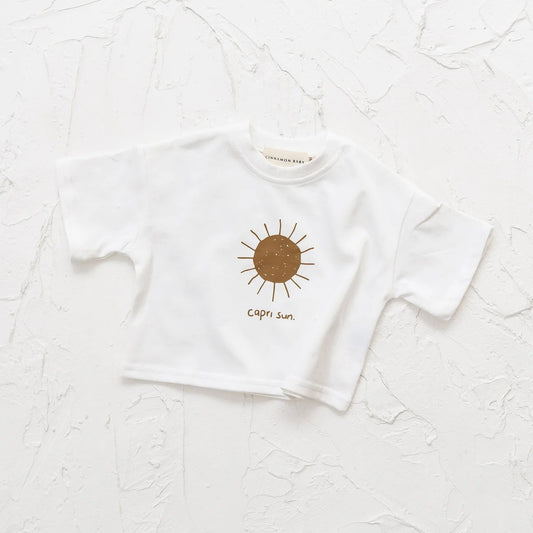 White t-shirt with a sun design and text on a textured white background