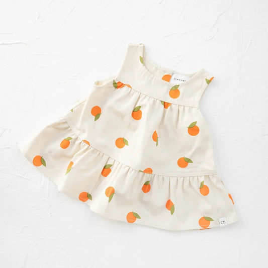 White dress with orange polka dots on a white background