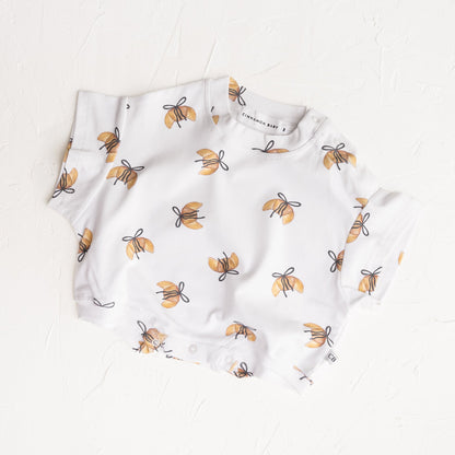 Baby romper with bee pattern on a white background