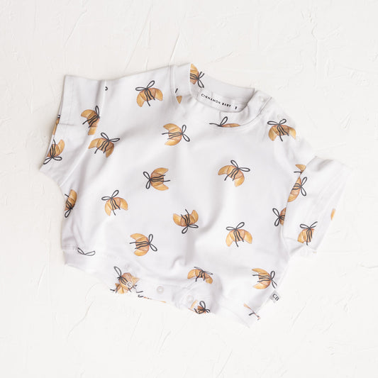 Baby romper with bee pattern on a white background