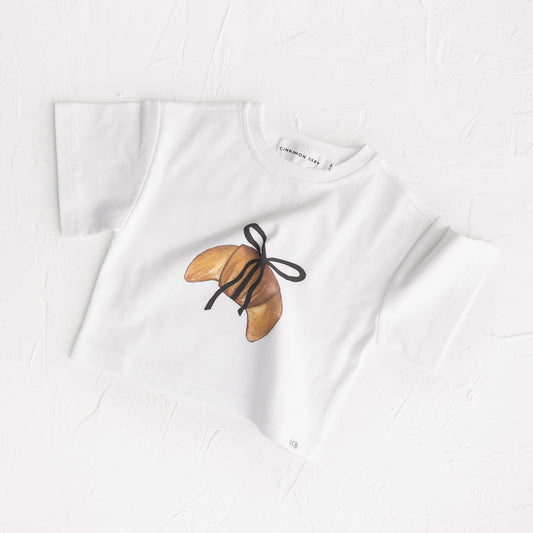 White t-shirt with a butterfly design on a white background