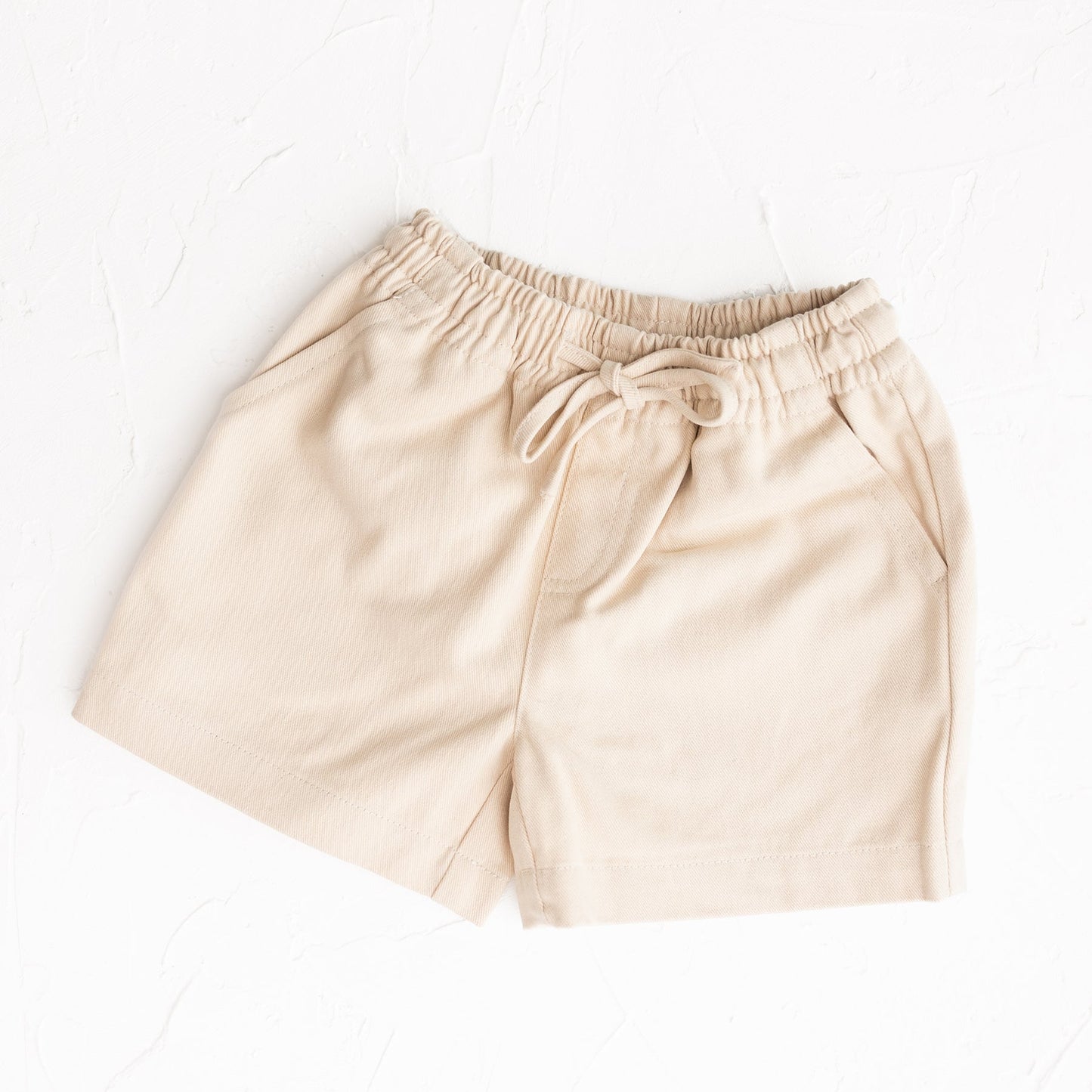 Beige shorts on a white background
