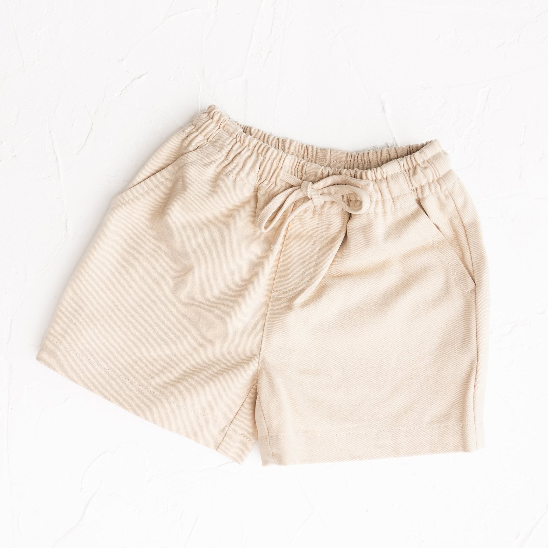 Beige shorts on a white background