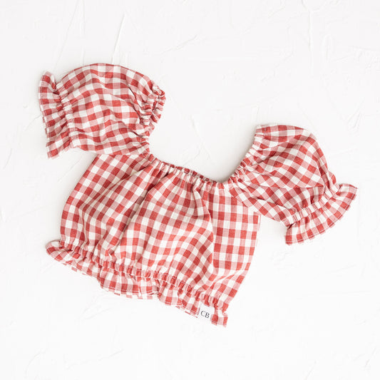 Red and white checkered top on a white background