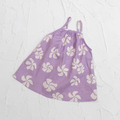 Purple dress with white floral pattern on a light gray background