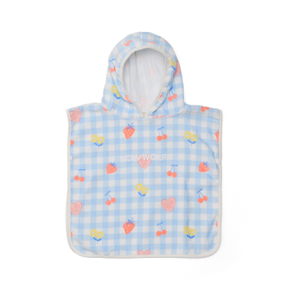 Children's poncho with hood and cherry pattern on a blue checkered background